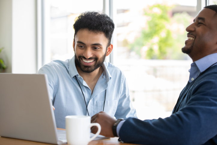 Two people looking at a laptop